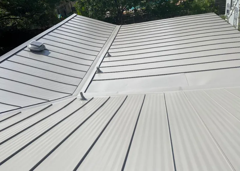 Solar attic fan installed on a metal roof for Roof Ventilation in Loves Park